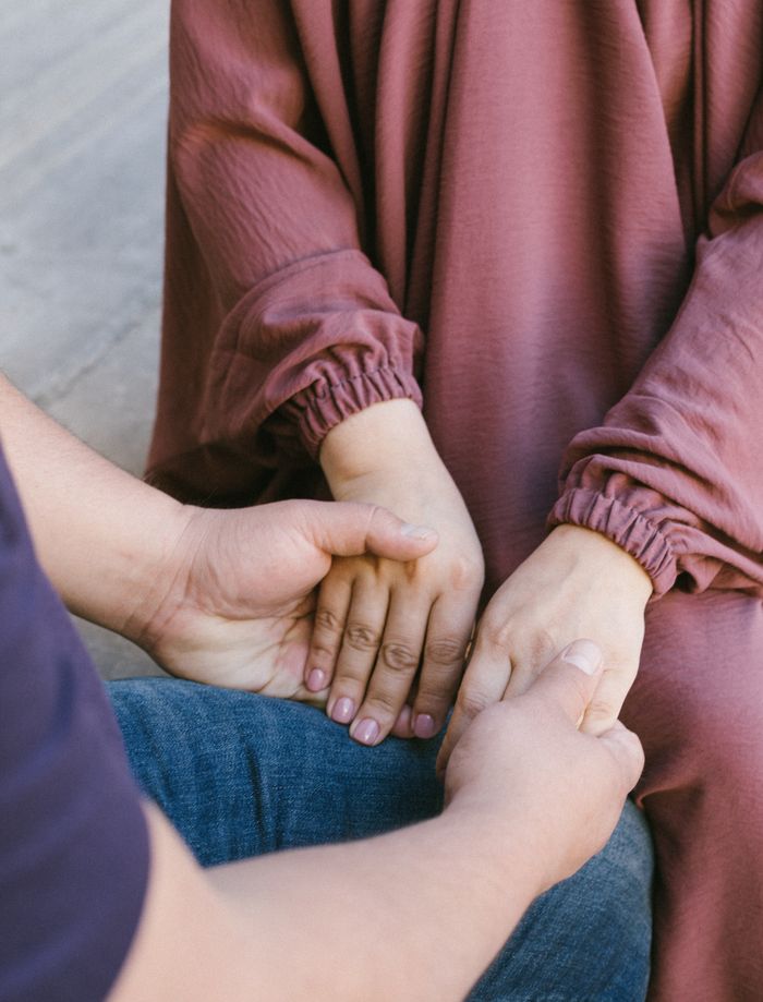 About Close-up of a couple holding hands, symbolizing love and connection.